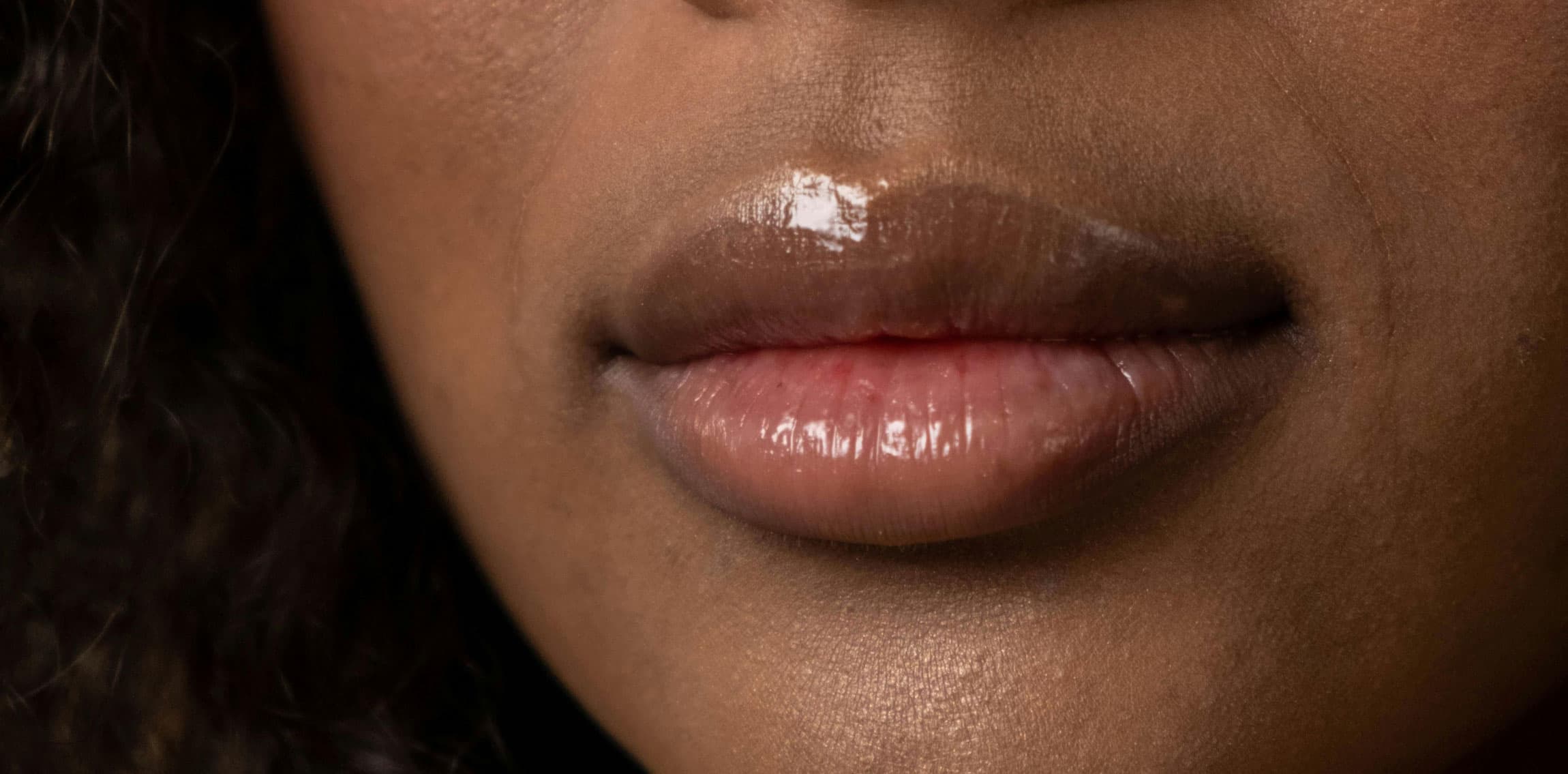 Woman wearing glossy lip balm